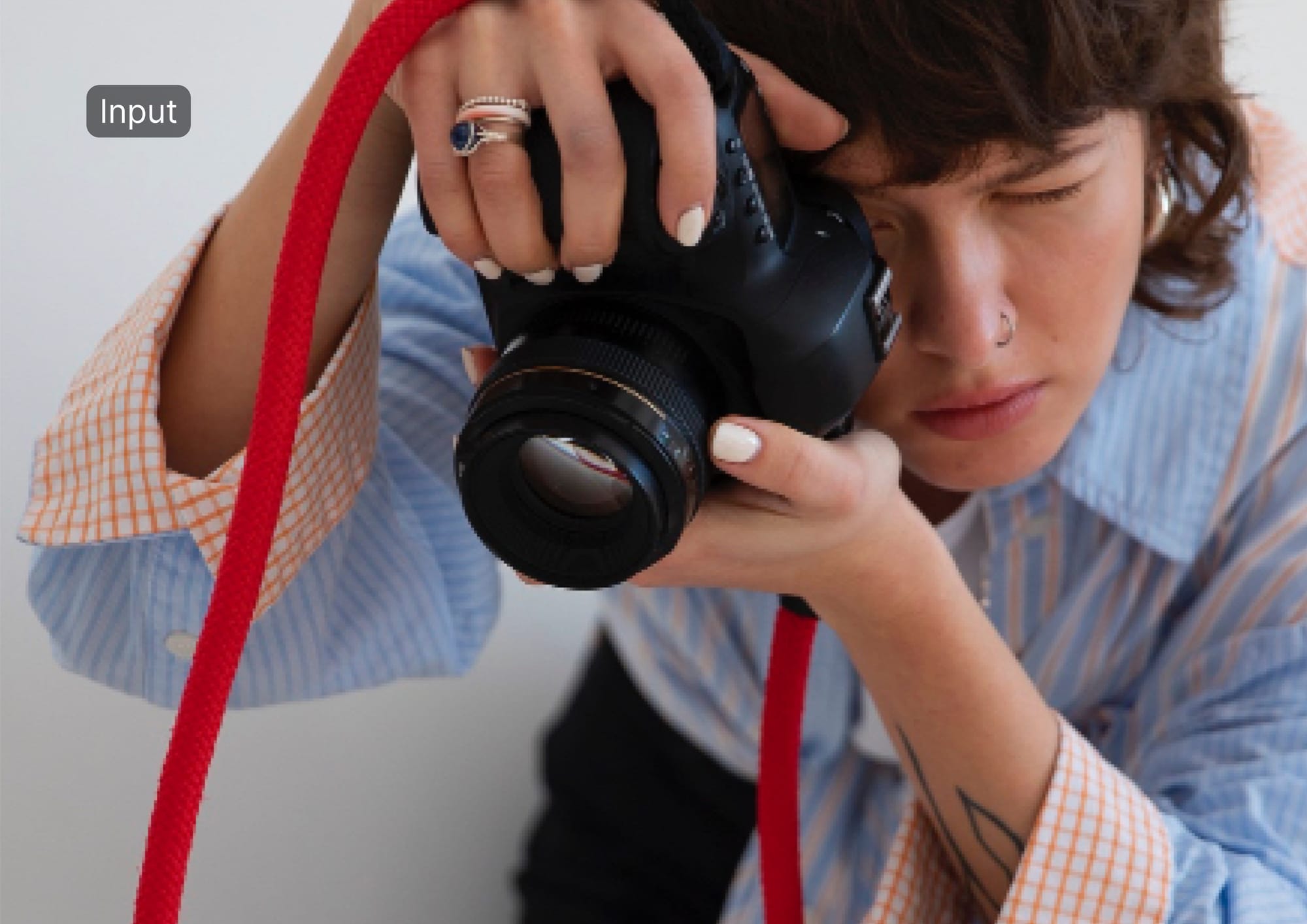 Person holding a camera used as input example for AI upscaling tests